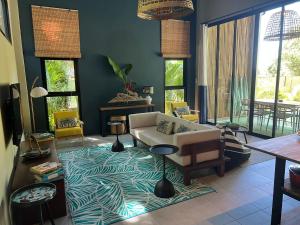 a living room with a couch and a rug at Villa IL SEGRETO Koh Samui in Ban Lamai