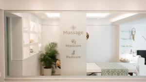 a store window with a sign that reads massage warehouse and furniture at Iria Beach Art Hotel in Agia Anna Naxos