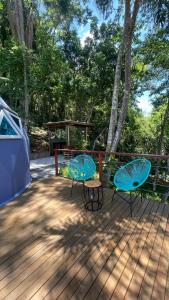 two tables and a gazebo on a deck at Domo do Arquiteto in Igaratá