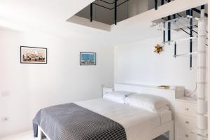 a white bedroom with a bed and a staircase at Villa Elisa by My Villa Collection in Conca dei Marini +22 photos