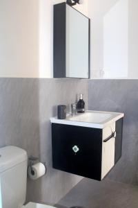 a bathroom with a sink and a mirror and a toilet at Residence A Paz in Boa Ventura +63 photos