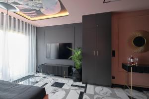 a bedroom with a bed and a tv on a wall at INA Rent - Apartamenty Czysta Delux in Wrocław