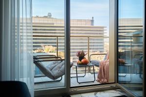 a balcony with a table and a chair on a balcony at INA Rent - Apartamenty Czysta Delux in Wrocław