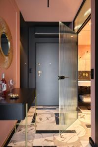 a glass door in a room with a table at INA Rent - Apartamenty Czysta Delux in Wrocław