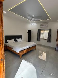 ein Schlafzimmer mit einem Bett und einer Decke in der Unterkunft Indraprastha Cottage in Alibag