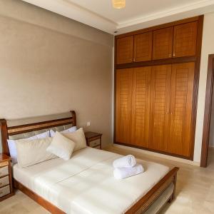 a bedroom with a bed with two towels on it at 3BR Near Airport Secure,Equipped stay and transit in Nouaseur
