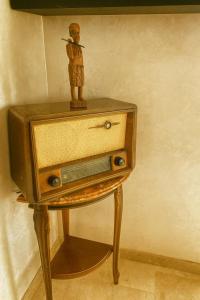 a small wooden figure on top of a dresser at 3BR Near Airport Secure,Equipped stay and transit in Nouaseur +4 photos