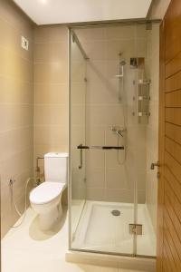a bathroom with a toilet and a glass shower at 3BR Near Airport Secure,Equipped stay and transit in Nouaseur