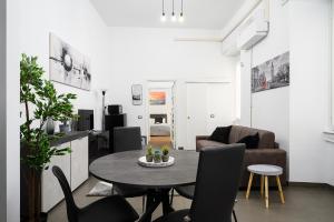 una sala de estar con una mesa y sillas en DUOMO Wonderful Apartment for 6, en Milán