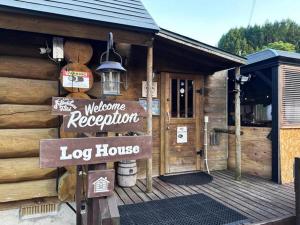 a log house with a sign in front of it at Kuruma Asobi Adventure Field Appi - Camp - Vacation STAY 42095v in Hachimantai