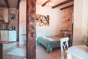 a small room with a bed and a kitchen at 2K Eco Pool & Stone Villa in Kriopigi