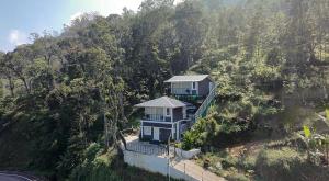 an aerial view of a house on a hill at Hornbill Resorts in Suryanelli