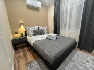 a bedroom with a bed with a night stand and a window at Live-In Room 5 - Klimatisiert - Coffee for free - in Karlsruhe