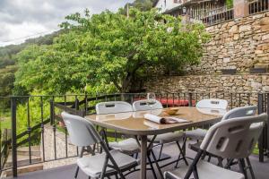 a table and chairs on a balcony with a tree at Armaño Rural (G-10069) in Tama