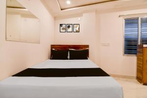 a bedroom with a white bed and a window at SPOT ON Night Owl Hotel &guest House in Bārāsat