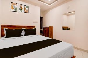 a bedroom with a large bed in a room at SPOT ON Night Owl Hotel &guest House in Bārāsat
