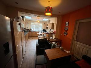 a kitchen with a refrigerator and a table in a room at spacious King bed 30FT Room in Kenton