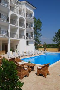 a hotel with chairs and a swimming pool at Residence Playa Sirena in Tortoreto Lido