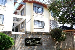 een gebouw met een bord ervoor bij Willary Heights Apartment in Bungoma