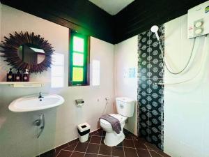 a bathroom with a toilet and a sink at Lanna Boutique Resort Chiang Mai in Chiang Mai +37 photos