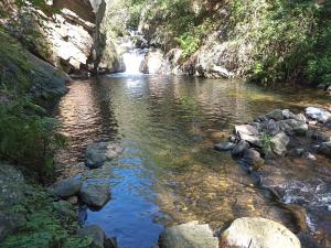 a river with a waterfall in the middle of it at Ecogite du Mas de Trape in Talau
