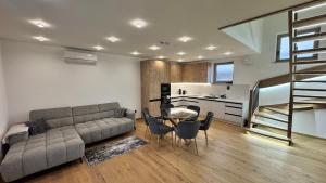 a living room with a couch and a table and a kitchen at Penzión Pri Mlyne in Nitra +127 photos
