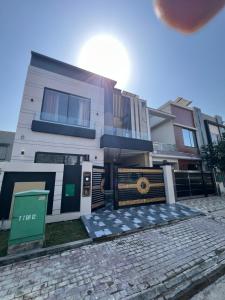 a house with a stone driveway in front of it at Brand New Vacation House in Lahore