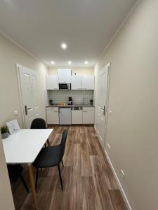 a kitchen and dining room with a table and chairs at Live-In Room 6 - Klimatisiert - Coffee for free - in Karlsruhe