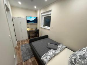 a small bedroom with a bed and a desk at Live-In Room 6 - Klimatisiert - Coffee for free - in Karlsruhe