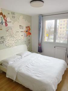 Ένα ή περισσότερα κρεβάτια σε δωμάτιο στο Au sud de Paris