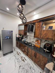 a kitchen with a marble counter top and a refrigerator at Brand New Vacation House in Lahore