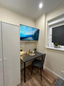 a table in a room with a chair and a tv at Live-In Room 6 - Klimatisiert - Coffee for free - in Karlsruhe +65 photos