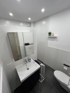 a white bathroom with a sink and a toilet at Live-In Room 6 - Klimatisiert - Coffee for free - in Karlsruhe