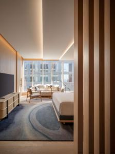 ein Schlafzimmer mit einem Bett, einer Couch und einem Fernseher in der Unterkunft Nobu Hotel Toronto in Toronto + 48 Fotos