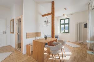 a living room with a wooden table and chairs at Alte Försterei Wildenthal - Ferienwohnungen in Eibenstock in Eibenstock +48 photos