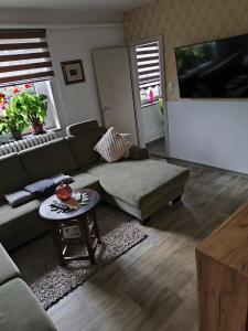 a living room with a couch and a table at Ferienwohnung Luka in Kaulsdorf