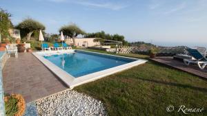 a swimming pool in the yard of a house at Villa Vigna in Camporosso