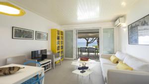 a living room with a white couch and a table at Villa Sand and Sea in Pelekas