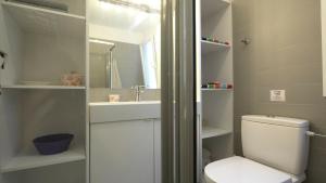 a bathroom with a toilet and a sink at Villa Sand and Sea in Pelekas +31 photos
