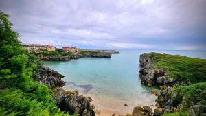 a view of a body of water with rocks at Apartamento Mirador Playa de Barro in Barro de Llanes