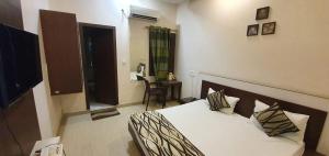 En eller flere senge i et værelse på Hotel Sunshine