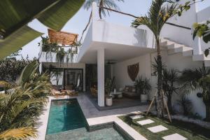 a villa with a swimming pool and a house at Private 1 bedroom villa with rooftop and pool in Tumbak Bayuh