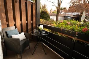 a small table and chairs on a balcony with plants at The Resting Place in Lemgo