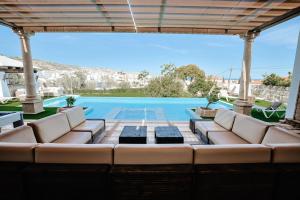 eine Terrasse mit einem Sofa und einem Pool in der Unterkunft Silversol in Jávea
