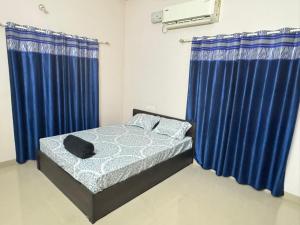 Ένα ή περισσότερα κρεβάτια σε δωμάτιο στο Zenways Retreat - Poovar