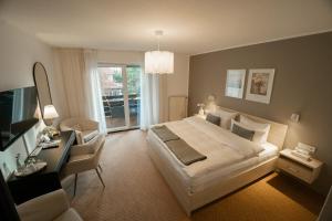 a bedroom with a bed and a desk and a television at The Resting Place in Lemgo