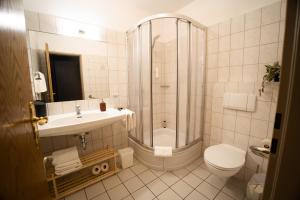 a bathroom with a shower and a toilet and a sink at The Resting Place in Lemgo +25 photos