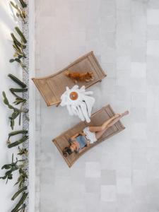 two people sitting on the beach on the floor at Private 1 bedroom villa with rooftop and pool in Tumbak Bayuh