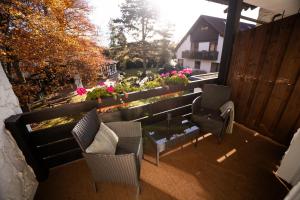 a balcony with chairs and a table and flowers at The Resting Place in Lemgo