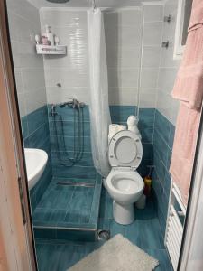 a small bathroom with a toilet and a sink at Serres Heart Suite in Serres